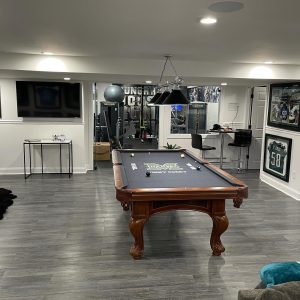 Basement sports bar with pool table and gym