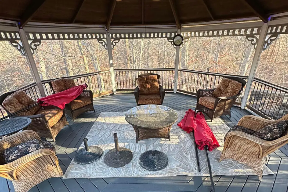 Cozy backyard gazebo with wicker furniture and wooden flooring, showcasing outdoor Deck Construction in Washington Township NJ.