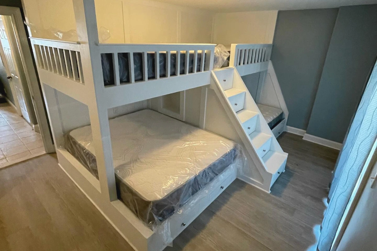 Custom bedroom room additions in washington township nj featuring built-in bunk beds, staircase access, and modern design in a bright remodeled space
