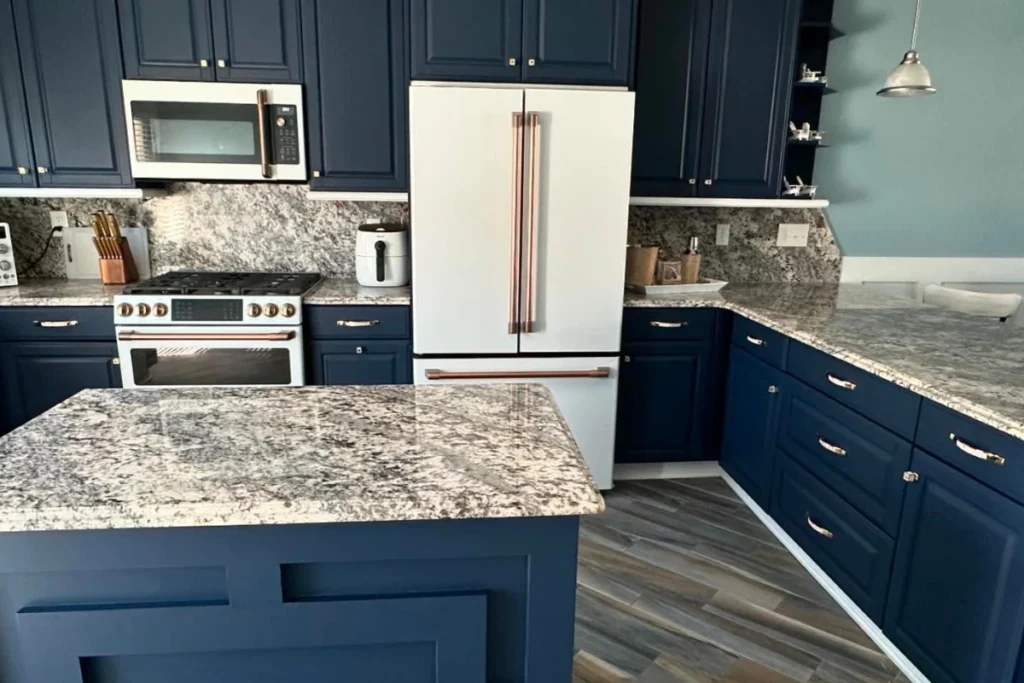 Modern kitchen remodel in Williamstown NJ completed by a General Contractor, featuring navy blue cabinets, granite countertops, and stainless steel appliances for a stylish home upgrade