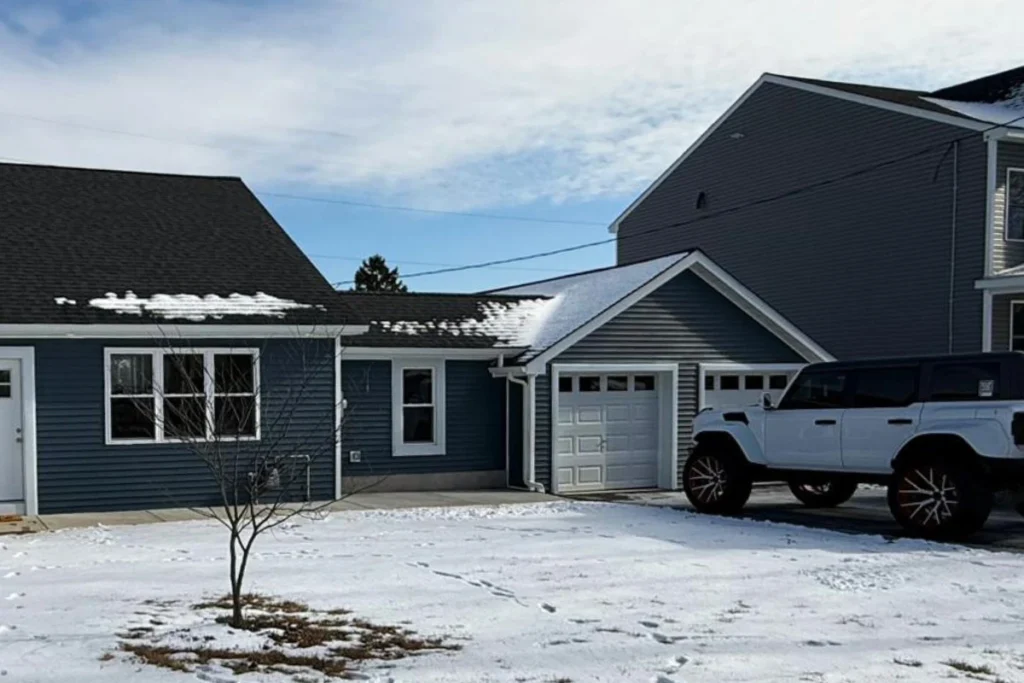 Modern Garage Construction in Washington Township, NJ, featuring white trim, a single-car garage door, and a snowy driveway.