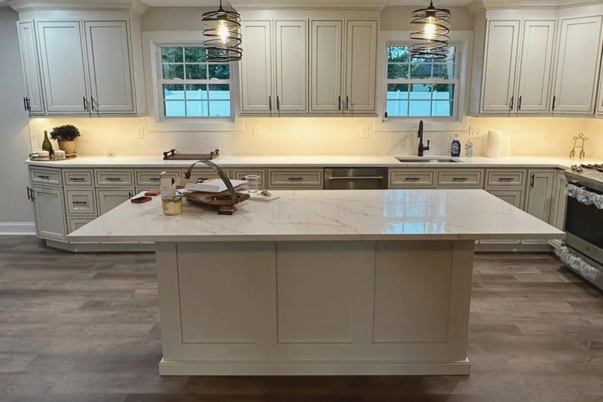 Modern Home Remodeling in Washington Township, NJ featuring white shaker cabinets, marble countertops, a large center island, and warm pendant lighting.