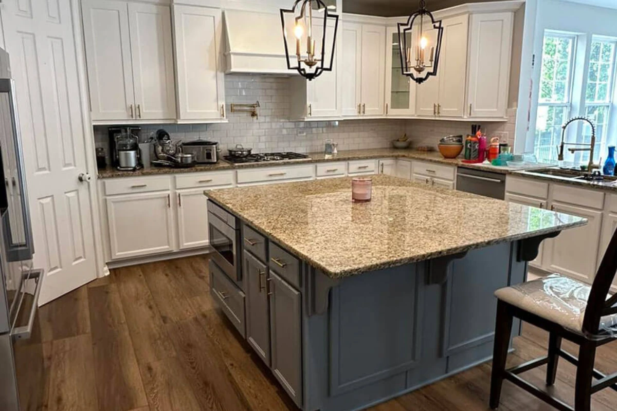 Modern kitchen remodeling in Pitman NJ featuring white shaker cabinets, granite island countertop, pendant lighting, and wood flooring.