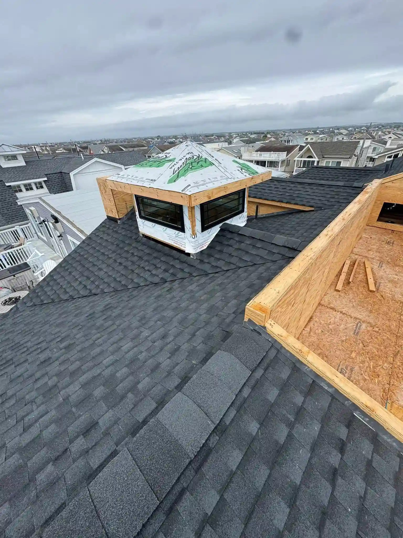 Roof replacement project in Washington Township, NJ by Showcase Remodels with crew working on residential home.