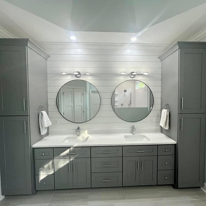 Bathroom renovation in Philadelphia featuring new tile, vanity, lighting, and fixtures.