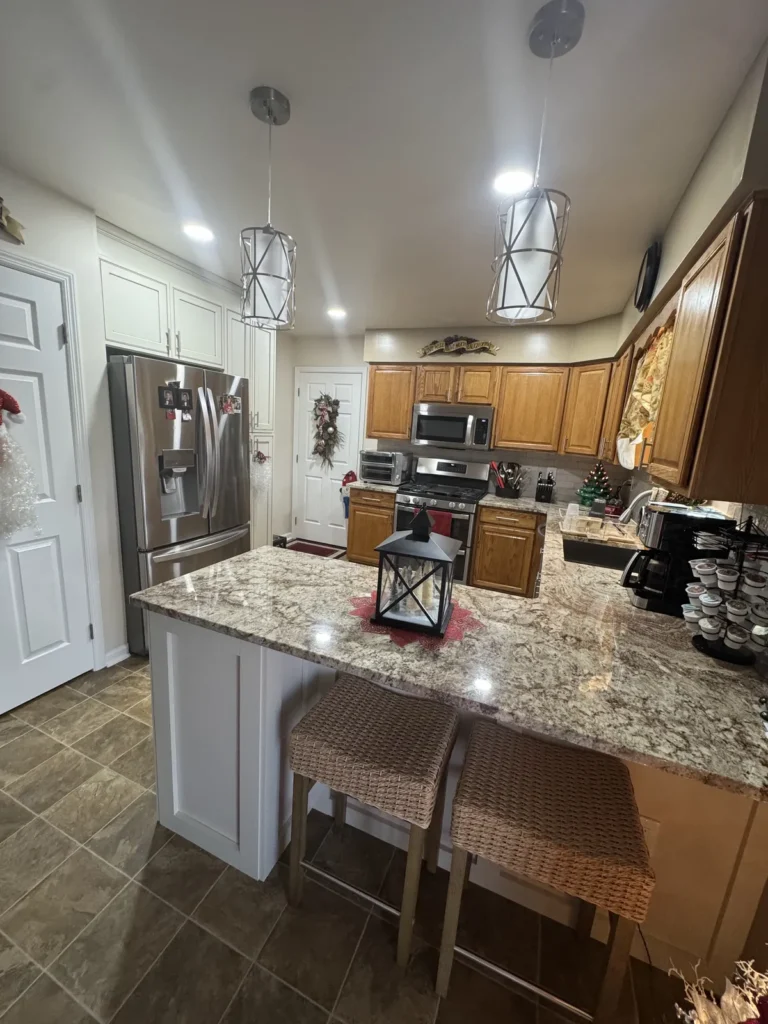 Kitchen island with granite countertop and pendant lights in Mayfair Philadelphia remodel