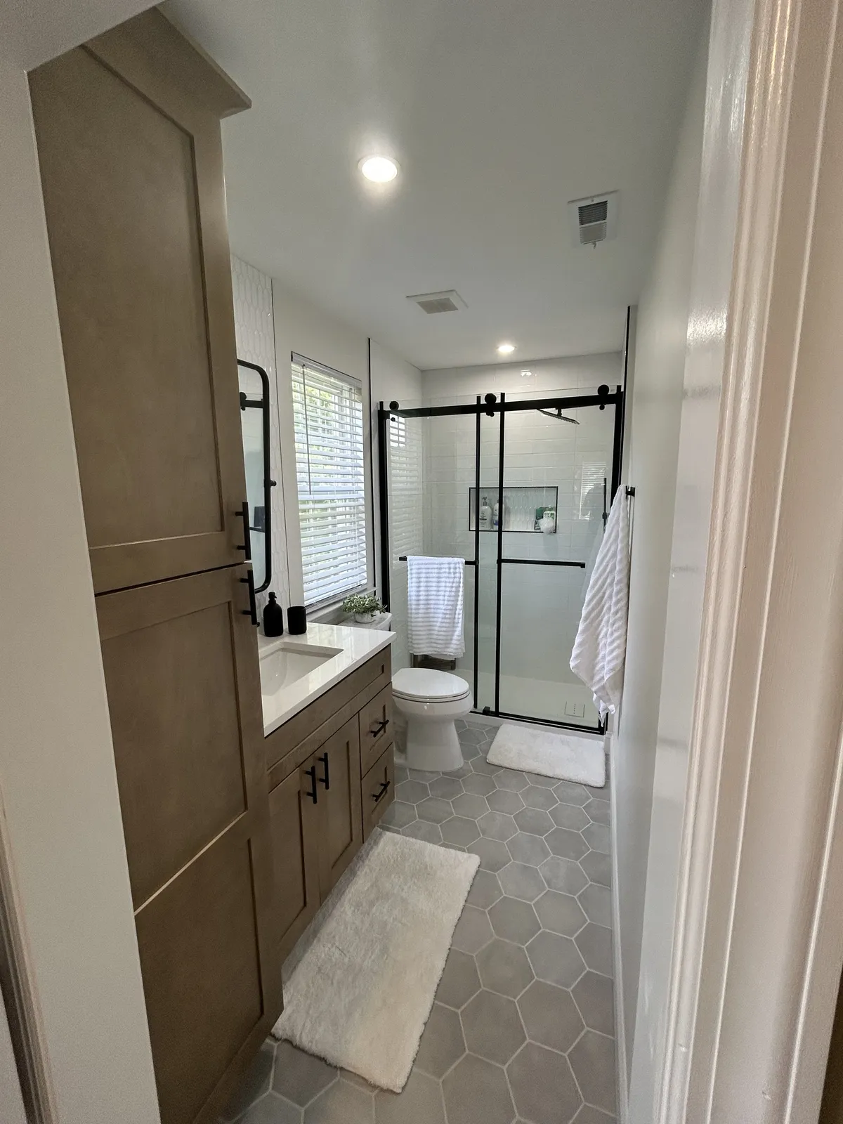 Full bathroom renovation in Philadelphia with double vanity and walk-in shower by Showcase Remodels