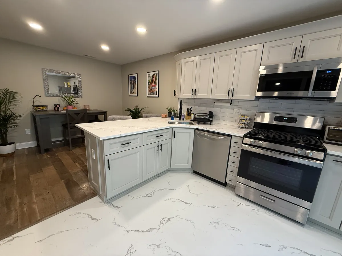 Complete kitchen remodel with white shaker cabinets and quartz countertops