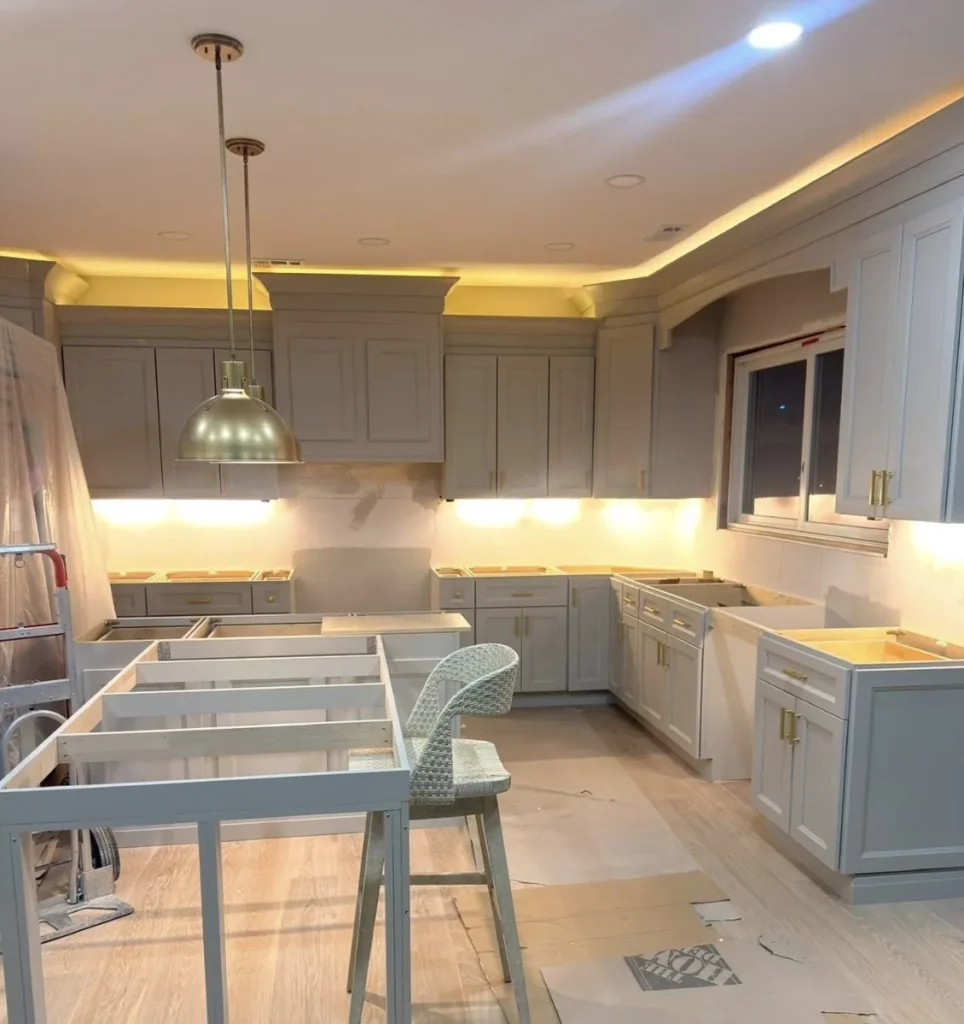 Custom kitchen with gray cabinets, brass hardware, and LED soffit lighting in a Bustleton whole-home renovation