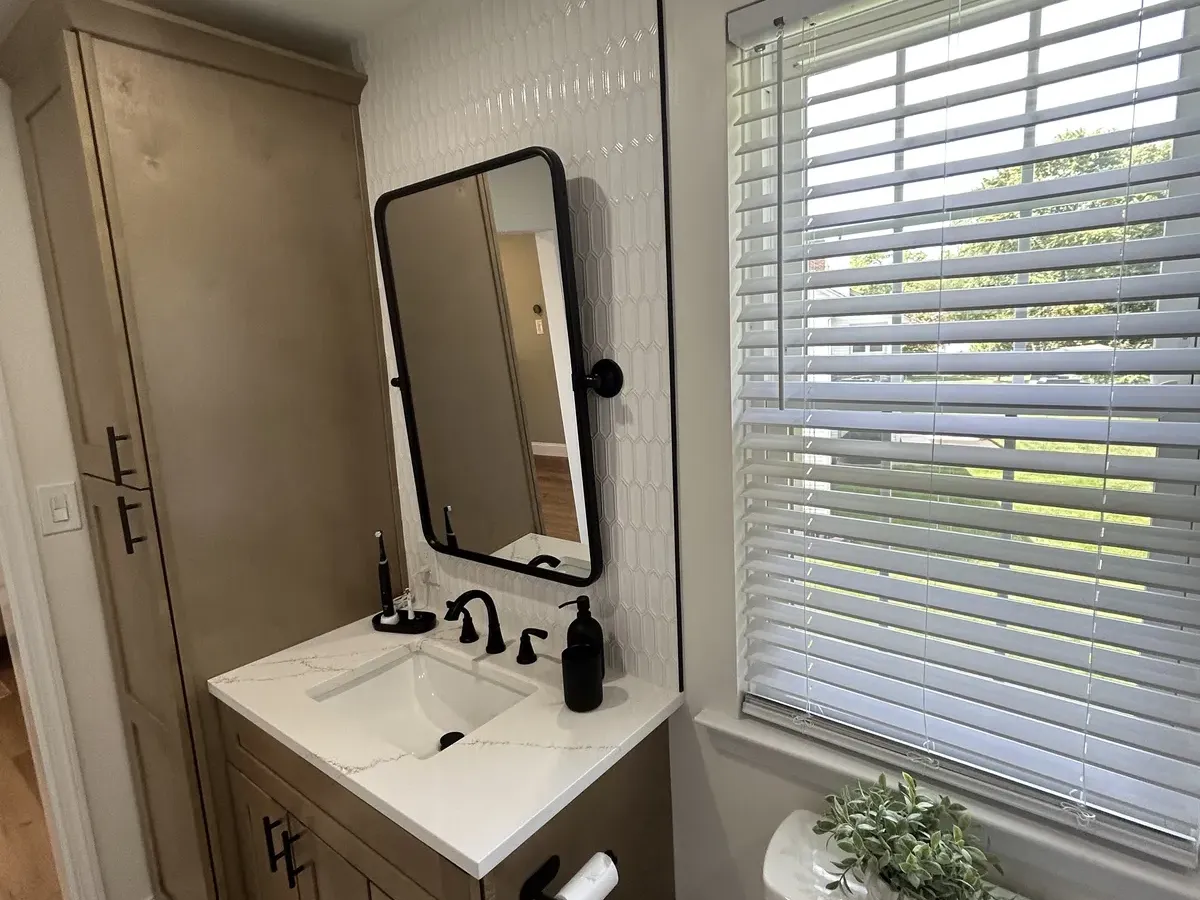bathroom renovation Philadelphia wood tone vanity quartz countertop black fixtures