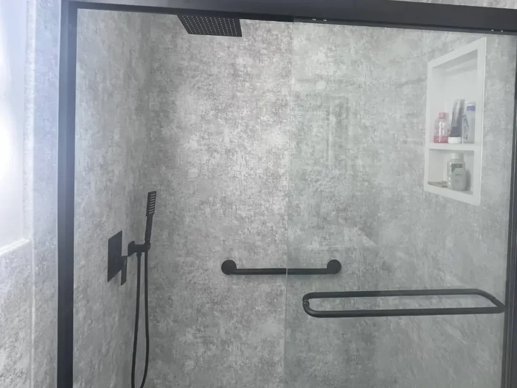 Walk-in shower conversion with frameless glass acrylic panels and curbless base in Philadelphia