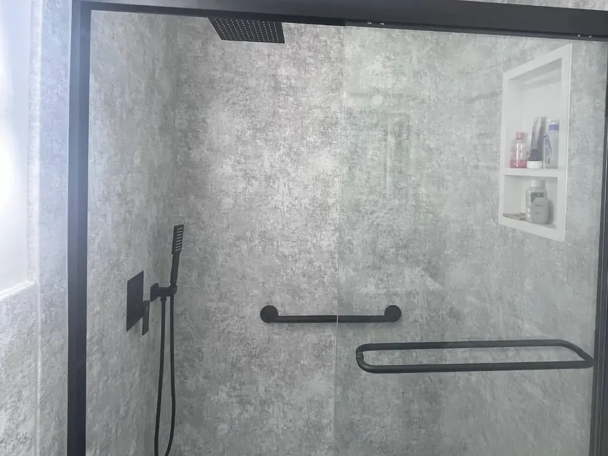 Walk-in shower conversion with frameless glass acrylic panels and curbless base in Philadelphia