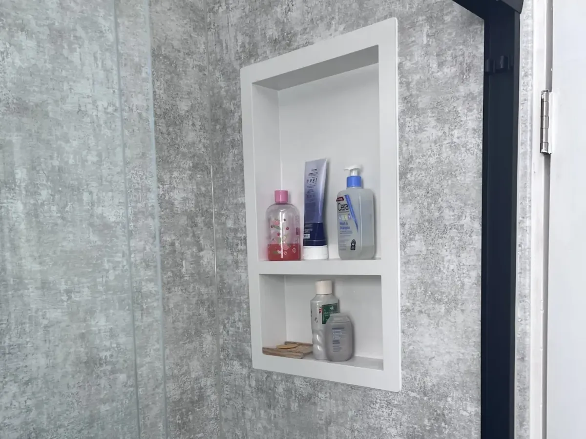 Frameless glass walk-in shower in Philadelphia bathroom with built-in niche and bench