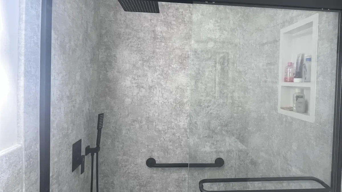 Walk-in shower renovation in Philadelphia with frameless glass enclosure and matte black fixtures