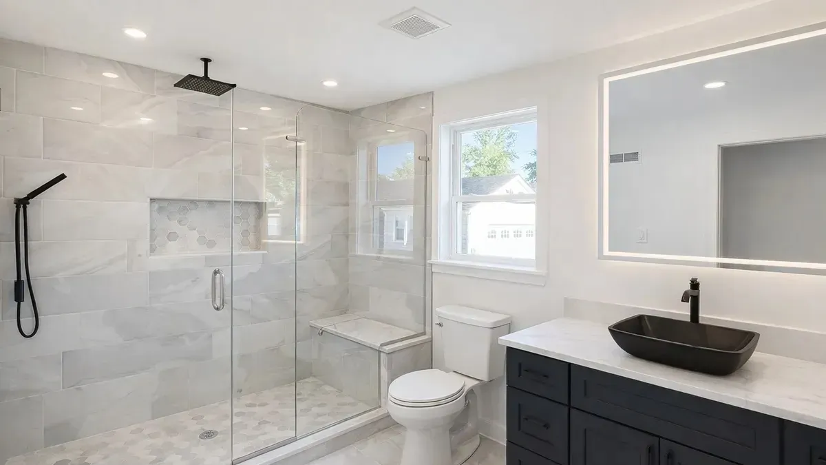 Marble shower with a bench and a vessel-sink vanity in Bridesburg, Philadelphia