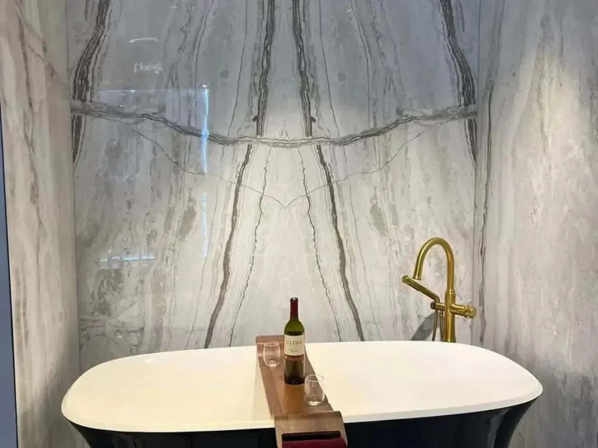 Black soaking tub set against a stone slab wall in Franklinville, Philadelphia
