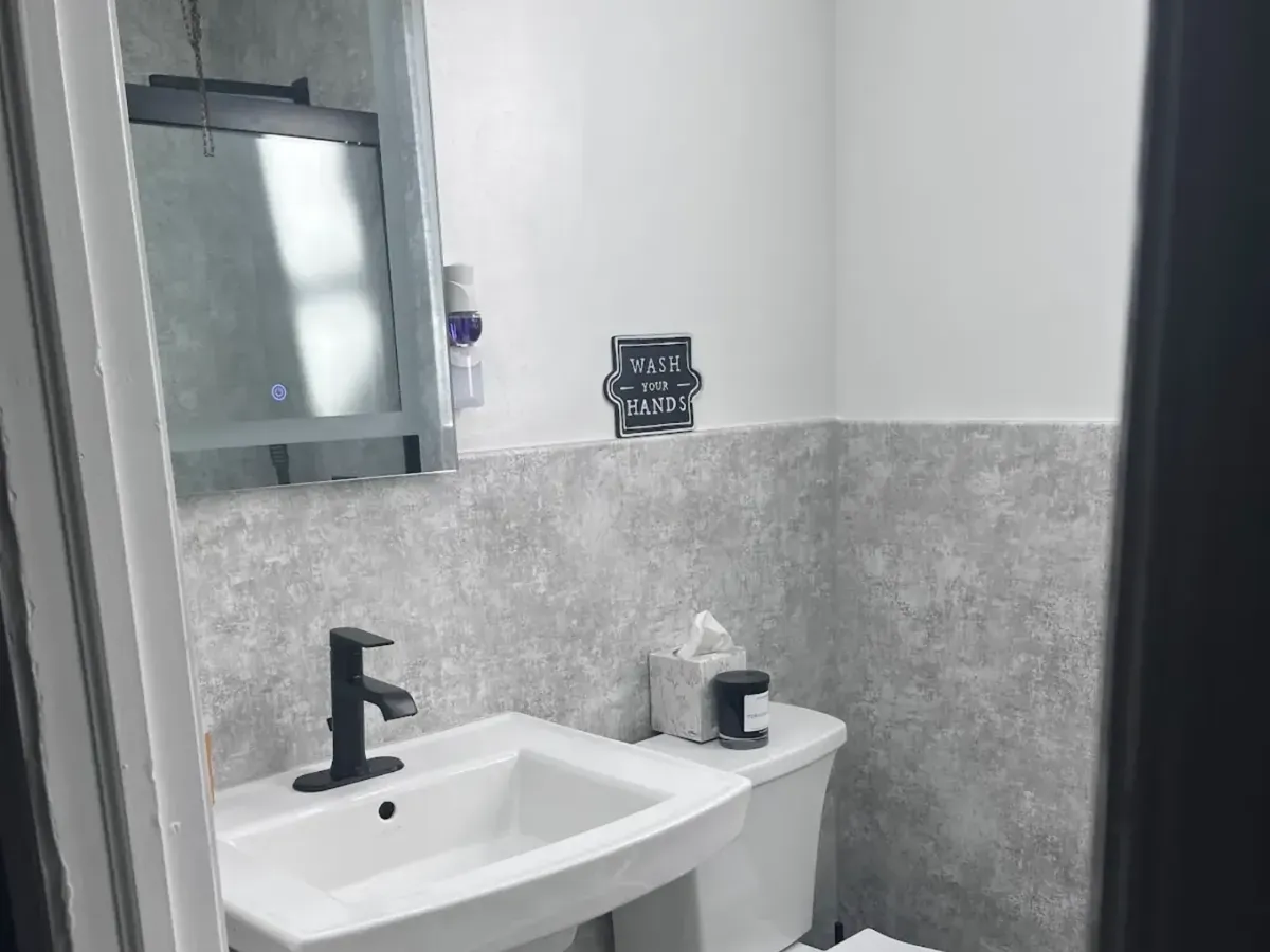 Pedestal sink and toilet in a small powder room in Hunting Park, Philadelphia