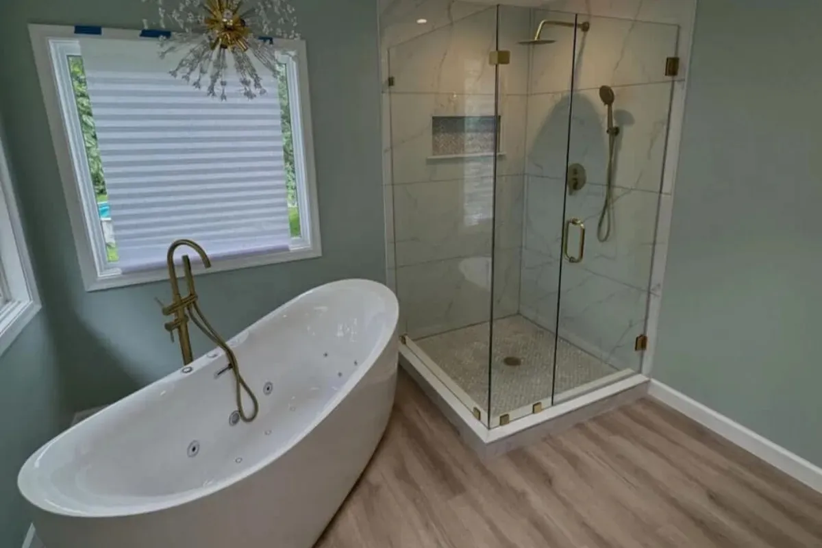Soaking tub and neo-angle glass shower with gold fixtures in Northern Liberties, Philadelphia