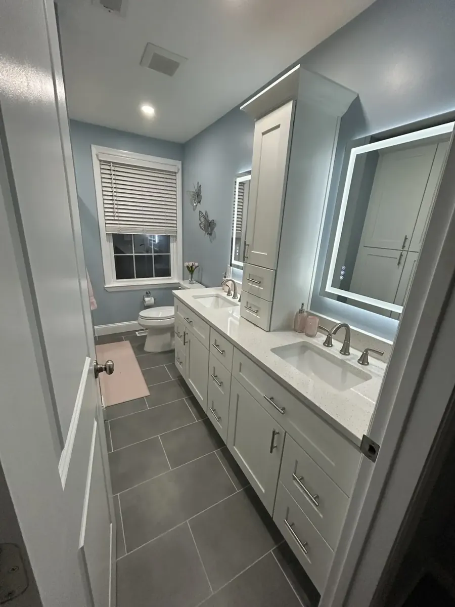 Long bathroom with a double vanity and large gray floor tile in Spring Garden, Philadelphia