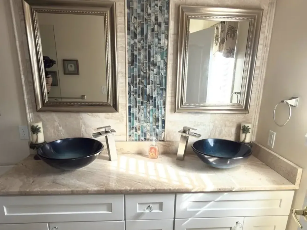 Vessel sink vanity under two framed mirrors in Strawberry Mansion, Philadelphia