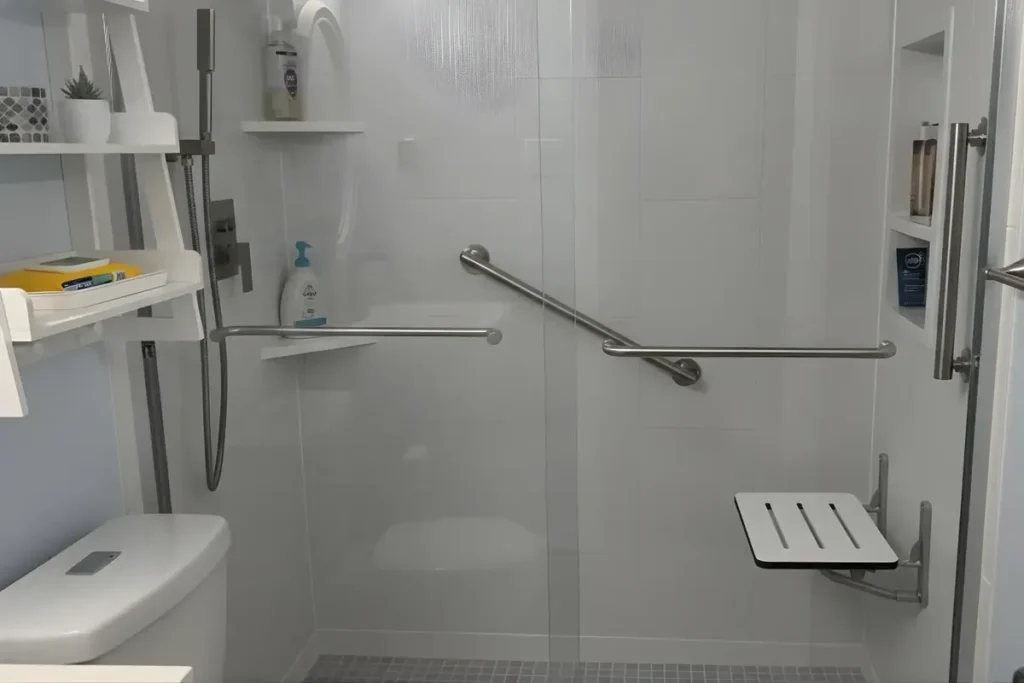 Walk-in shower with white wall panels, a grab bar and a fold-down seat