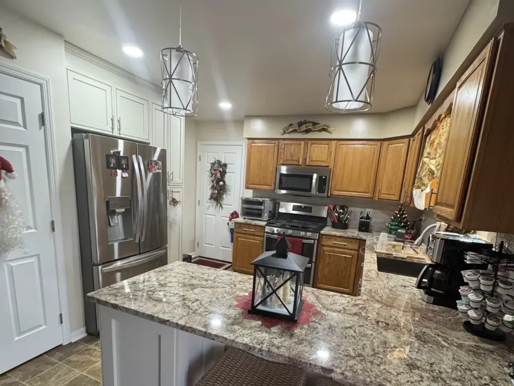 Wood cabinets and a granite topped island in a custom kitchen design in Philadelphia