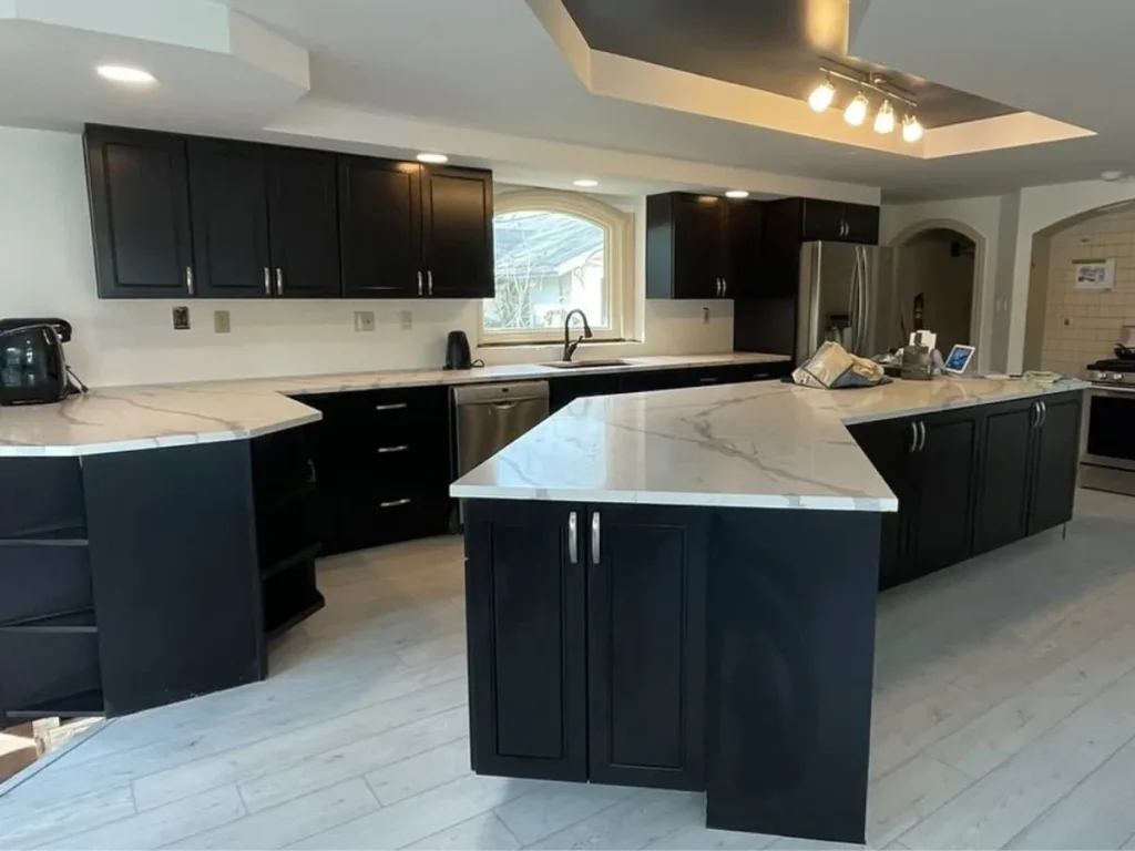 Dark base cabinets and a quartz peninsula adding storage in a Philadelphia kitchen remodel